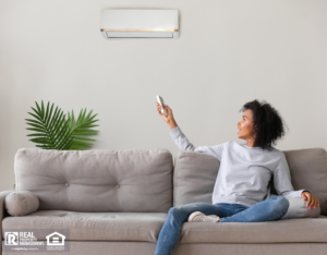 Woman controlling new air conditioning unit with remote